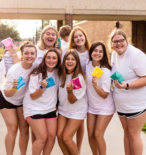 students posing together on campus